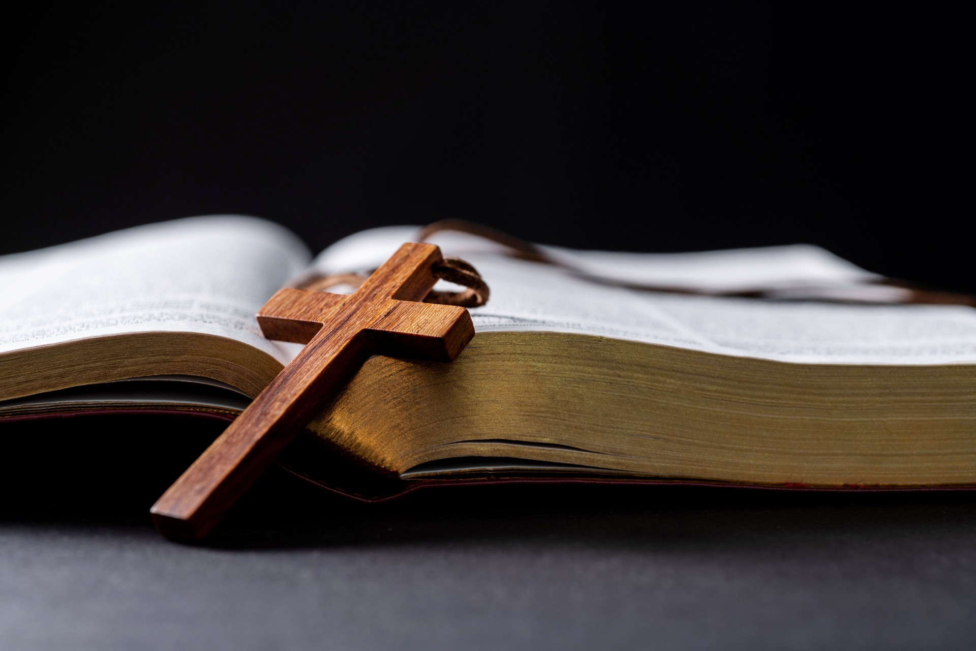 Wooden cross and bible on the table